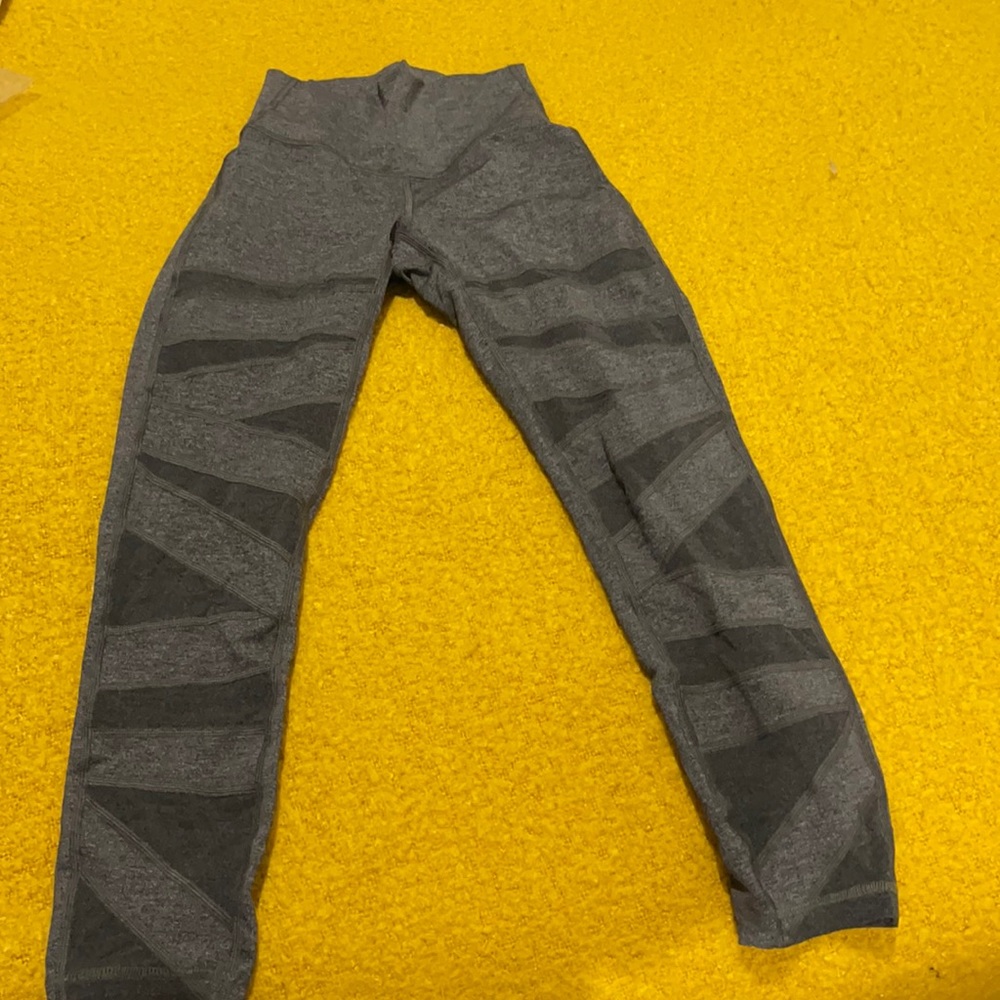 Lululemon grey leggings- new size 2 and cut is 7/8 length, detailing down leg